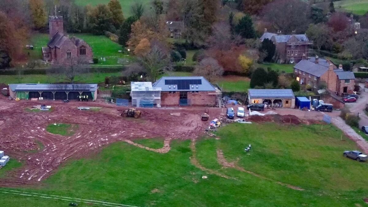 An aerial photo of solar panels on a barn conversion and garage