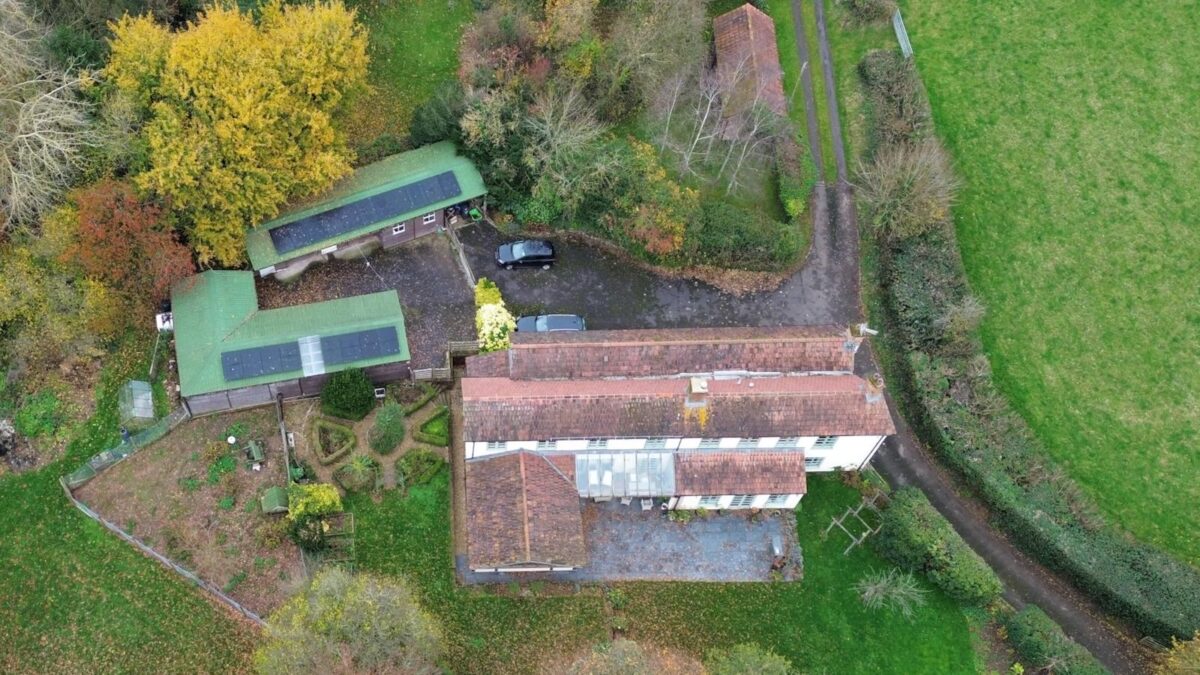 An aerial photo of solar panels on farm outbuildings