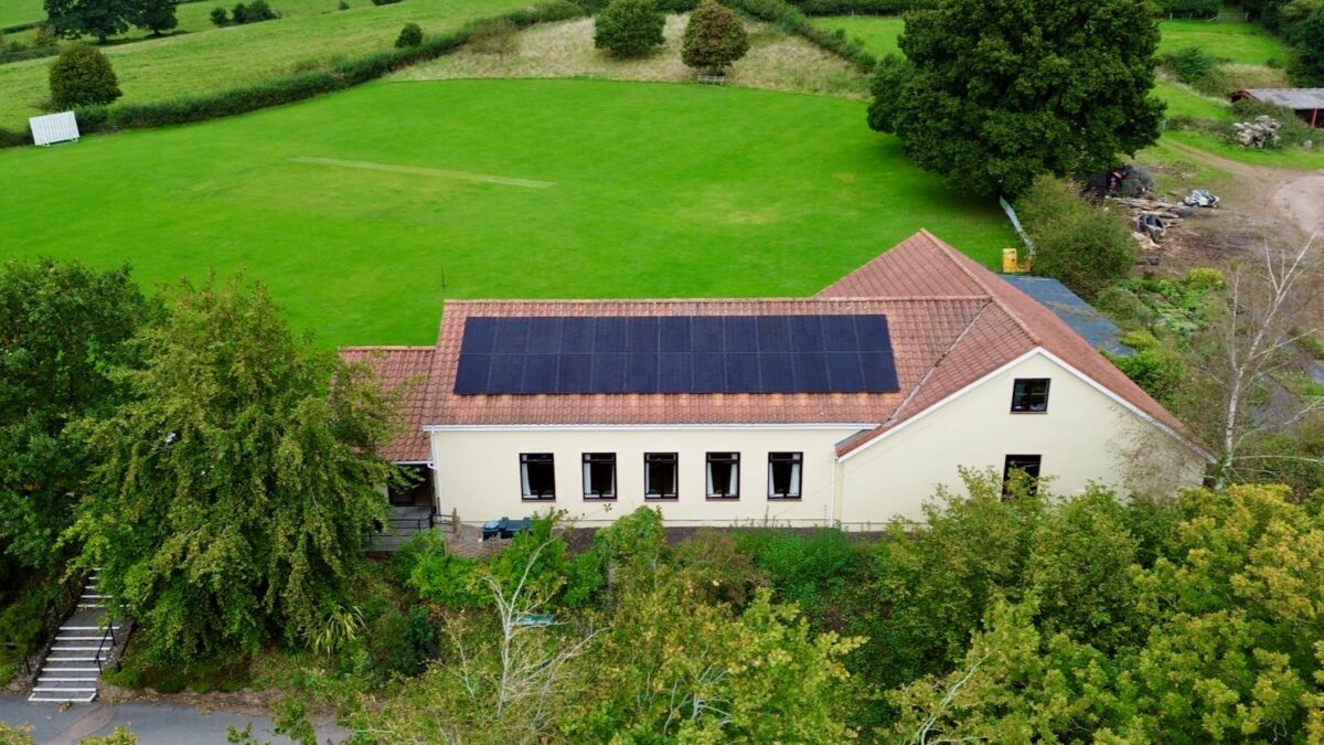 An aerial photo of solar panels on a cricket pavilion