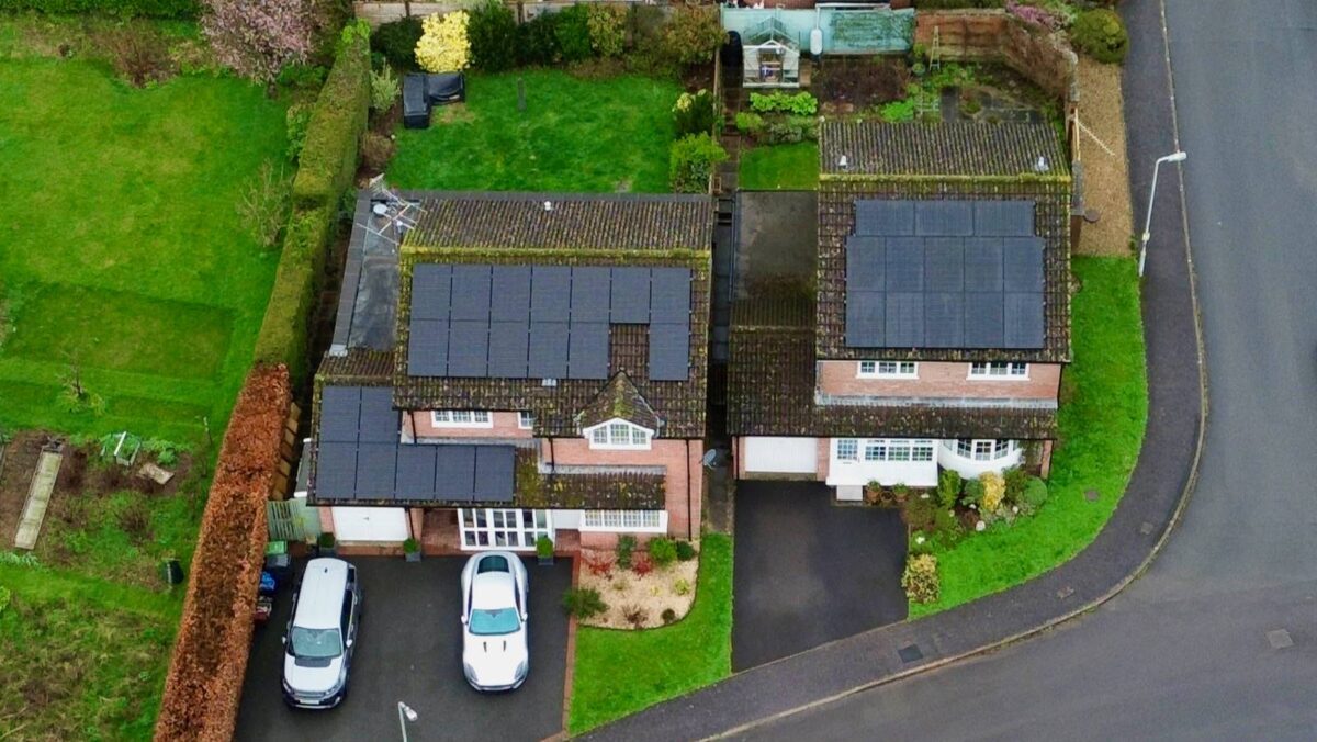An aerial photo of solar panels on two houses