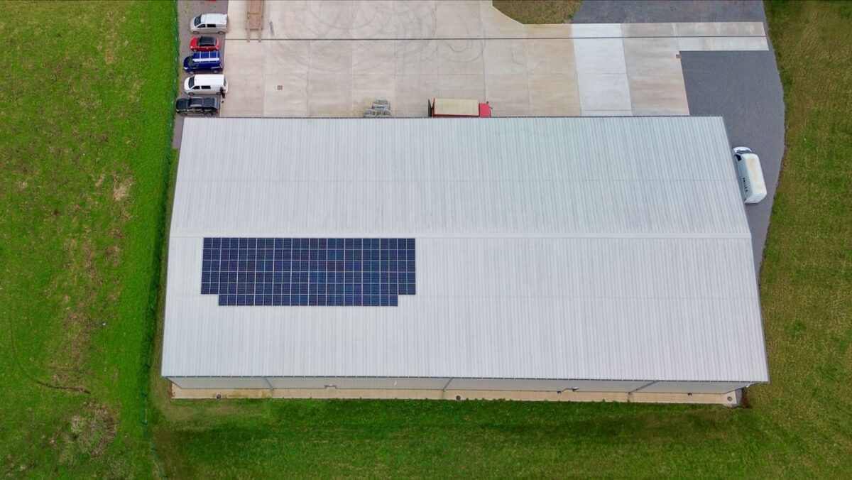 An aerial photo of solar panels on a barn roof
