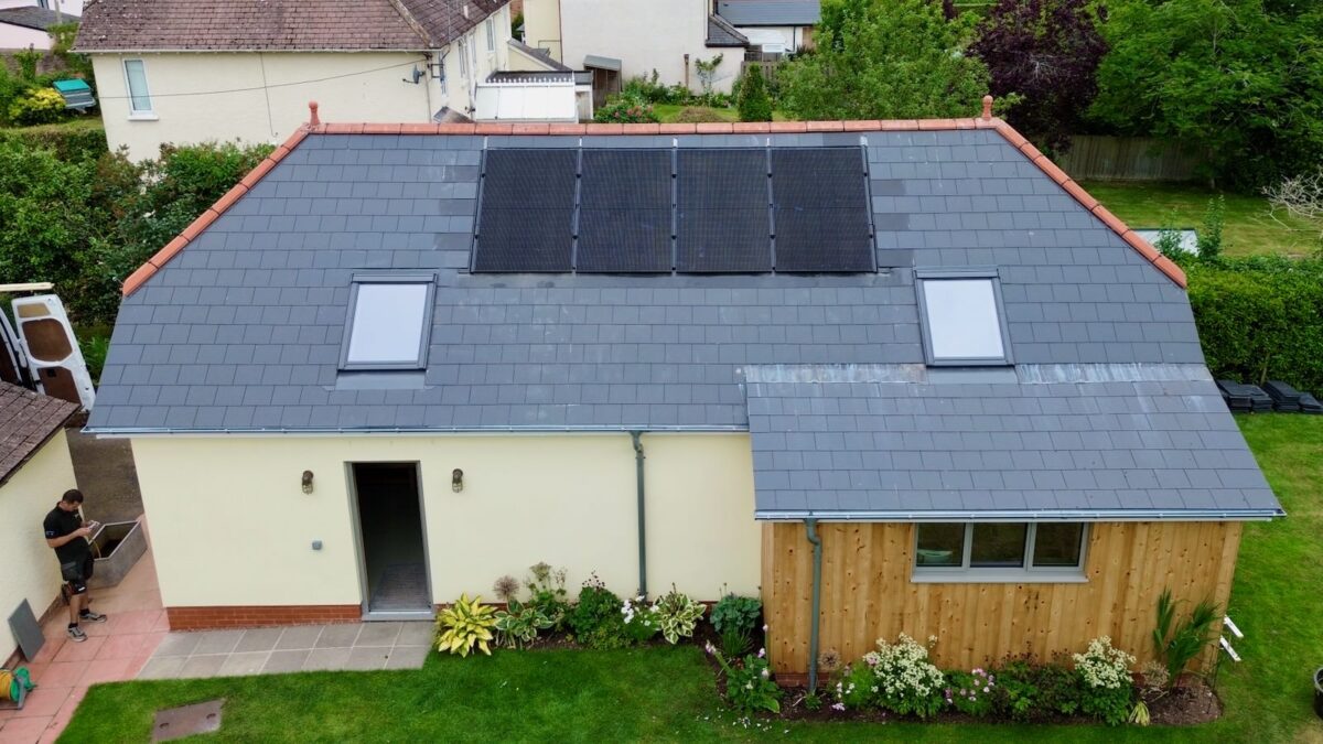 An aerial photo of solar panels on an outbuilding