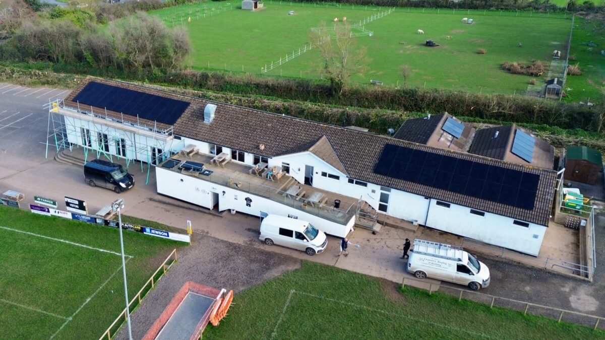 An aerial photo of solar panels on a sports pavilion