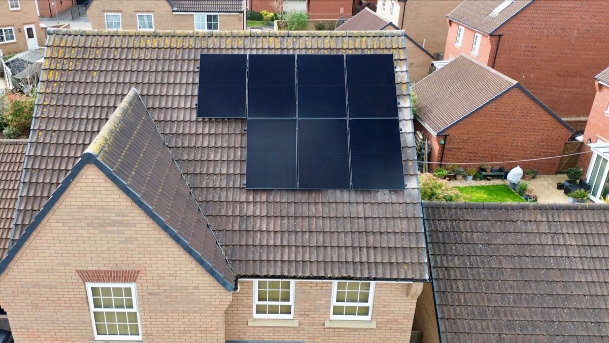 An aerial photo of solar panels on a house